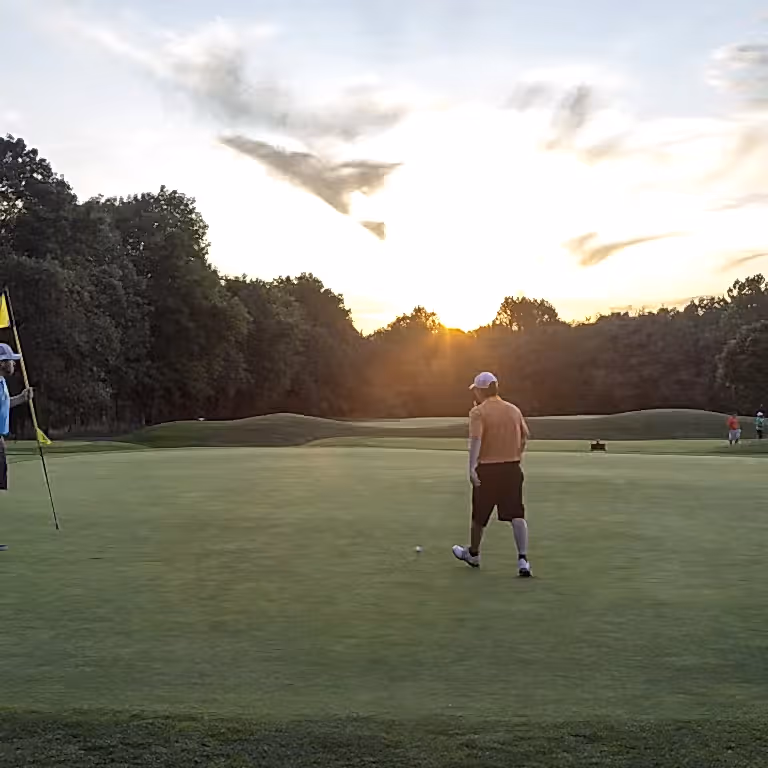 Two men on the putting green of Black Bear Golf Course