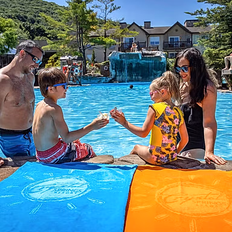 Children enjoying ice cream by the pool with their parents at Minerals Hotel