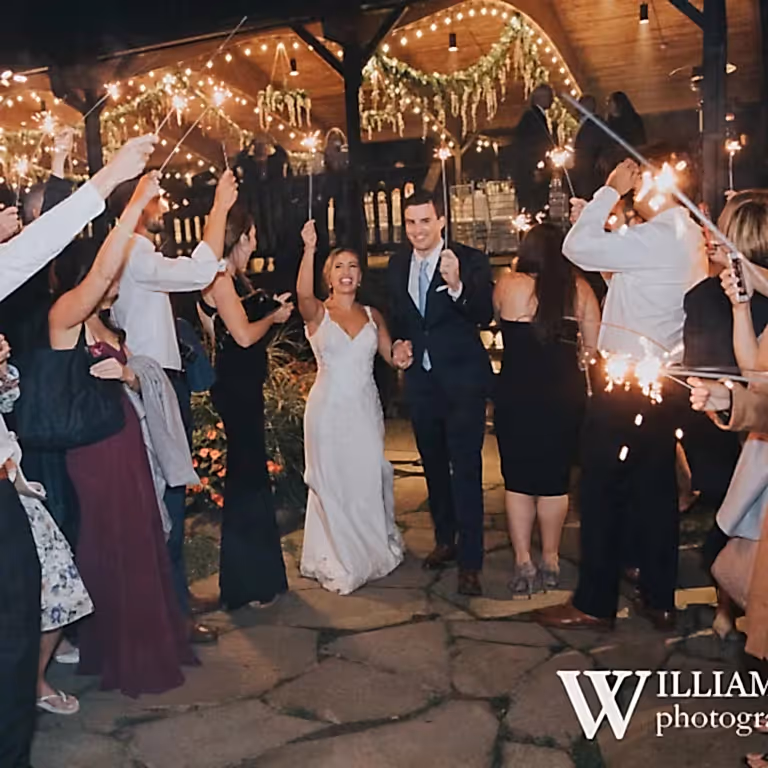 Wedding couple walking through sparklers