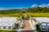 Ballyowen Wedding Garden ceremony featuring white chairs and floral arch.