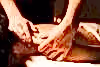 Hands pinching shoulder giving massage.