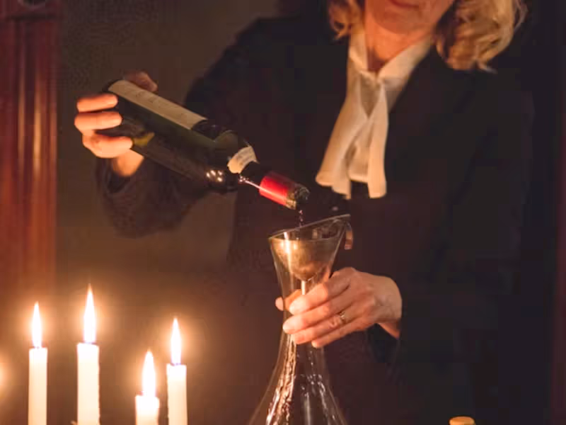 Susanne Wagner pouring wine into a decanter.