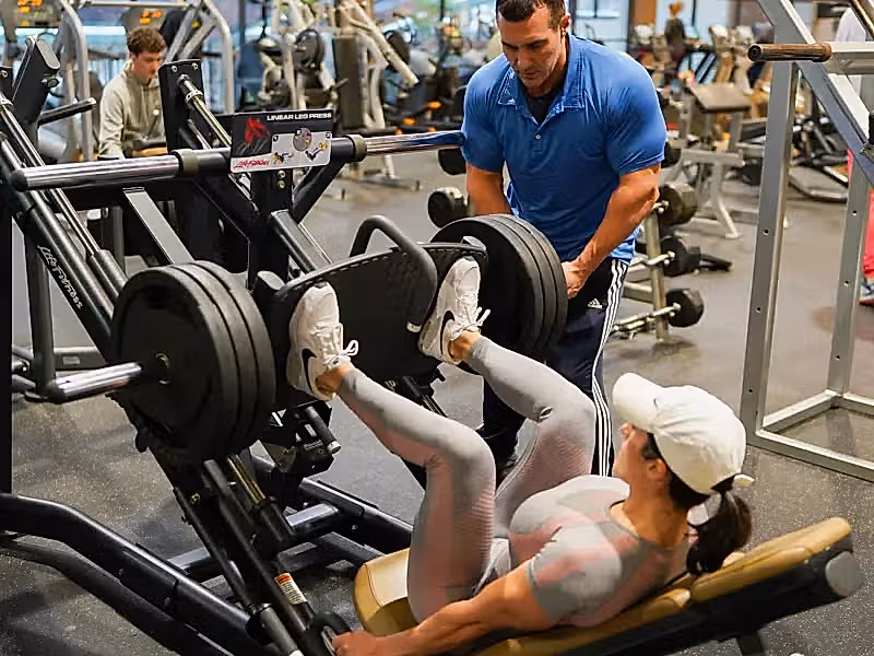 Woman working out using leg press at Minerals Sports Club.